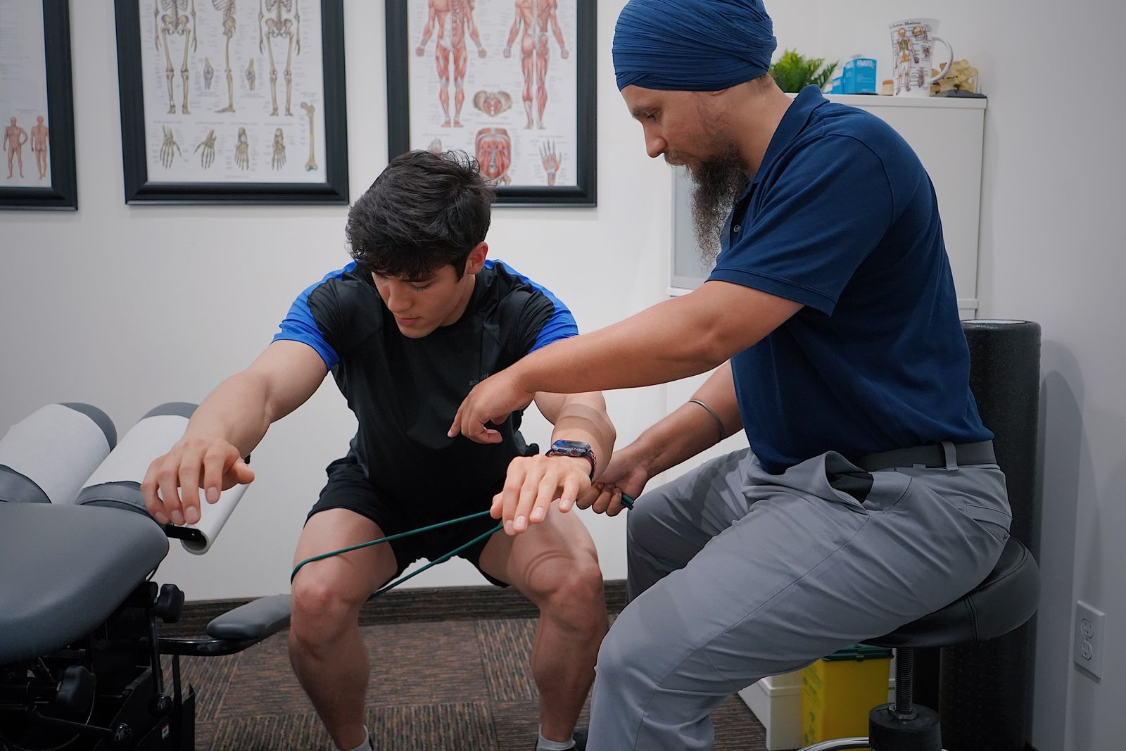 Indian physiotherapist guiding a patient through rehabilitation